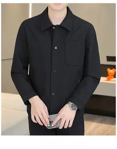 Detail of black shirt jacket featuring fine vertical texture and metal snap buttons