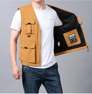 Detail of camel utility fishing vest showing inner pocket with INSPIRE OTHERS text