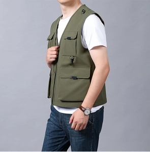 Detail of army green functional vest featuring multi-pocket design for outdoor use