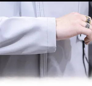 Close-up of light gray men's jacket cuff featuring smooth tech fabric and Typhoon ribbon detail