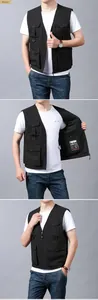 Detail of black fishing vest showing breathable mesh lining and tactical utility pockets