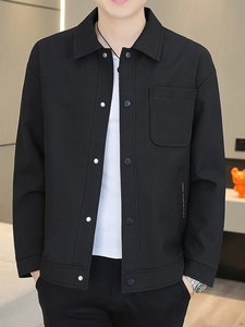 Men's black casual shirt jacket with textured fabric, metal buttons, and chest pocket