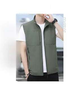 Detail showing the stand-up collar and secure zipper pockets of the green outdoor vest