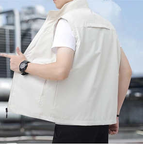 Rear view detail of cream outdoor vest showing stand collar and functional back seams