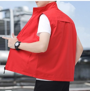 Side view of men's bright red outdoor vest featuring zip pockets and stand-up collar