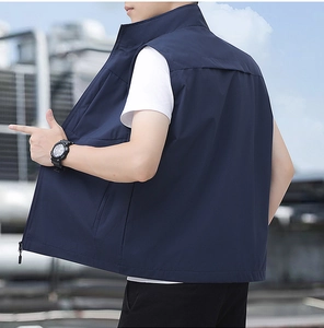 Detail view of the navy blue outdoor vest featuring a stand collar and secure zip pockets