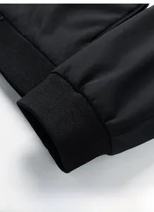 Close-up of black casual jacket sleeve showing elastic ribbed cuffs and premium fabric