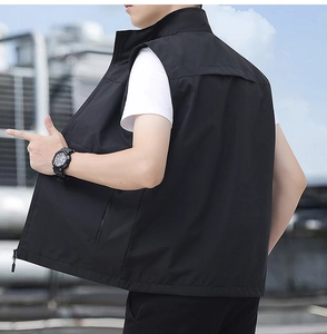 Detail view of the back and side cut of a black lightweight outdoor vest for men