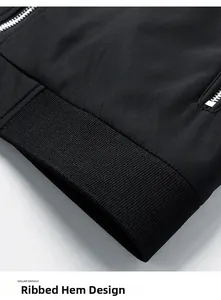 Detailed close-up of a black casual jacket with ribbed hem and metallic silver zipper
