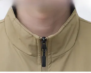 Detail view of khaki vest showing high-quality metal zipper and precision stitching on collar
