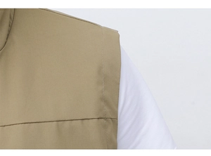 Close-up of double stitching on khaki fishing vest shoulder with durable fabric detail