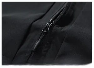 Detail view of high-quality smooth metal zipper on a black outdoor leisure vest