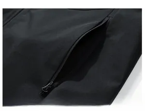 Detailed close-up of a secure hidden side pocket with zipper pull on a black tactical vest