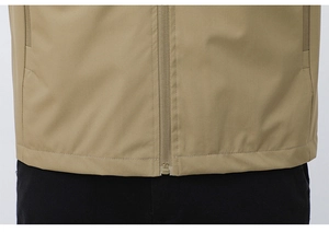 Detail of khaki outdoor vest showing smooth central zipper and hidden side pockets