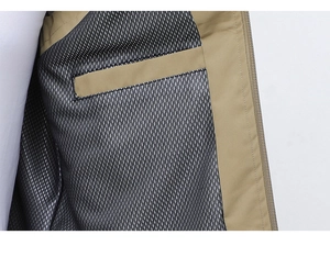 Close-up of khaki vest interior featuring breathable gray mesh lining and internal pocket