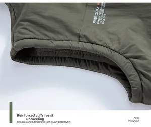 Detail of overlocked armhole on army green utility vest showing durable stitching