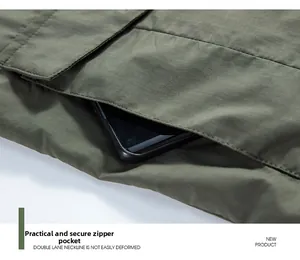 Detail of hidden zipper pocket on green outdoor vest showing secure smartphone storage