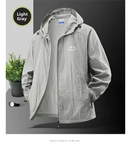 Detail of light gray sun protection jacket with outdoor logo and zip pocket