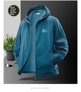 Detail of men's denim blue sun protection jacket with hood and mountain chest print