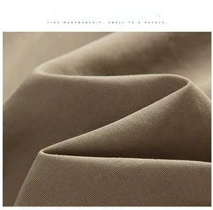 Detailed macro view of khaki soft-shell fabric texture for outdoor jackets