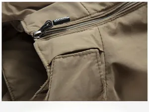 Detailed macro view of khaki jacket neckline featuring a fashion zipper puller cord