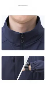 Detail view of navy blue jacket showing stand collar zipper, side pocket and elastic cuff