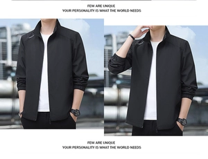 Detail view of men's black stand collar windbreaker with white lettering on the shoulder