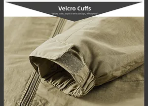 Detail of adjustable velcro cuffs on windproof khaki outdoor jacket with zipper detail