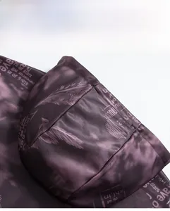 Detail of a purple camouflage hoodie featuring a smooth cotton blend fabric and hood design