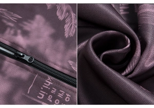 Detailed macro of the purple camouflage fabric with feather pattern and black metal zipper