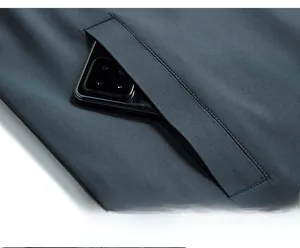 Detail view of large side pocket on dark grey jacket showing spacious storage capacity