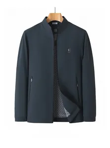 Detailed view of dark blue standing collar jacket with zipper pockets and logo