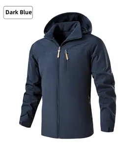 Detail of dark blue outdoor jacket showing chest zipper pocket and mountain logo