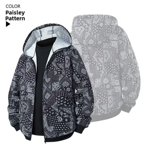 Detail of zip-up hoodie featuring black and white paisley print with ribbed cuffs