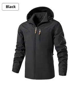 Detail of black outdoor jacket featuring mountain embroidery and zipper with leather pull