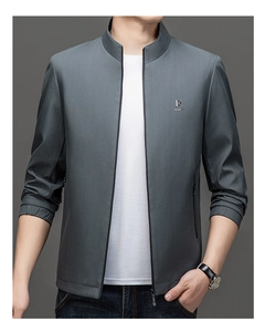 Detail of grey stand collar jacket showing textured fabric and elastic cuff design