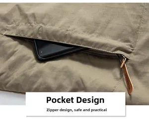 Detail of khaki outdoor jacket showing zippered pocket with brown leather puller