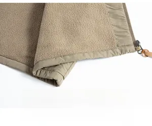 Detail view of khaki fleece jacket lining with premium zipper and leather puller
