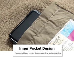 Detail of a practical inner pocket on a brown fleece jacket holding a smartphone and magazine