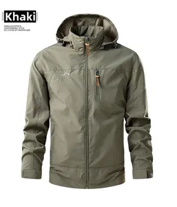 Detail of khaki outdoor jacket showing chest zipper pocket and mountain logo print