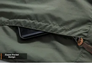 Detail of army green outdoor jacket featuring a secure zipper pocket for smartphone storage
