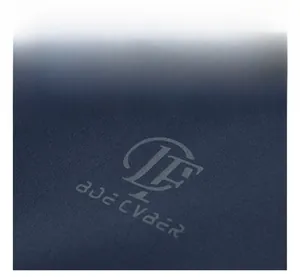 Macro detail of the high-quality navy blue jacket showing the printed chest logo