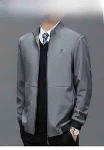 Detailed view of the men's grey business jacket with embroidered logo and stand collar