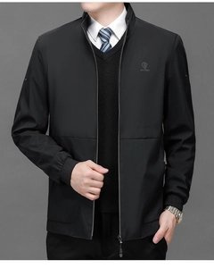 Detail of a men's business jacket showing the stand collar, metal zipper, and logo embroidery
