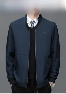 Detail of royal blue business jacket with stand collar and logo embroidery