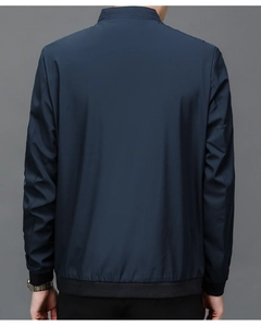 Rear view of navy blue business jacket with stand collar and ribbed hem details