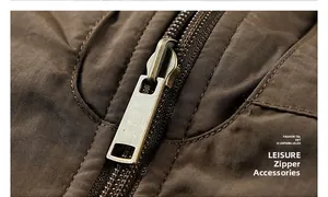 Macro shot of durable vintage bronze metal zipper head on brown outdoor vest fabric