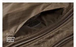 Detail of brown outdoor vest featuring velcro pocket and durable metal zipper closure