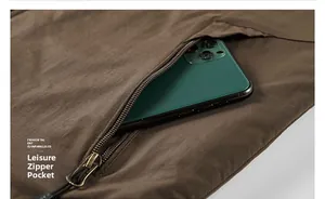 Close-up of functional zipper pocket on warm vest showing capacity for a smartphone