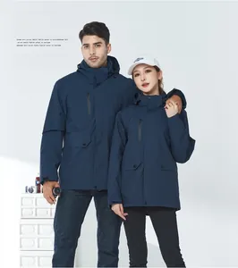 Front view of couple wearing dark blue waterproof outdoor jackets with hoods and pockets